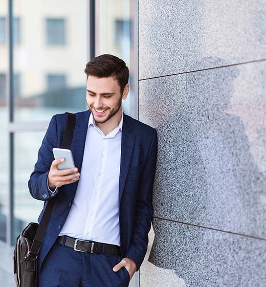 Man looking at mobile phone with app for home security