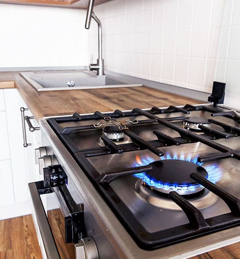 Gas stove in kitchen left on which is a hazard for combustible gas explosion