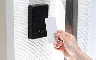 an access control proximity key card reader being used