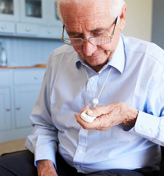 senior man using a medical alert device