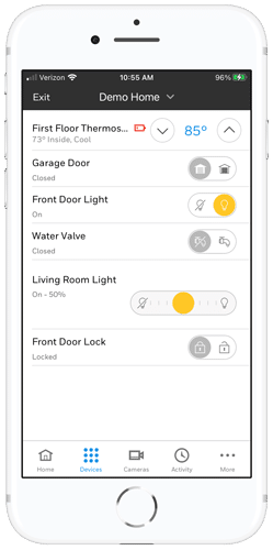 mobile phone with open app showing different home automation controls like temperature, lights, locks.