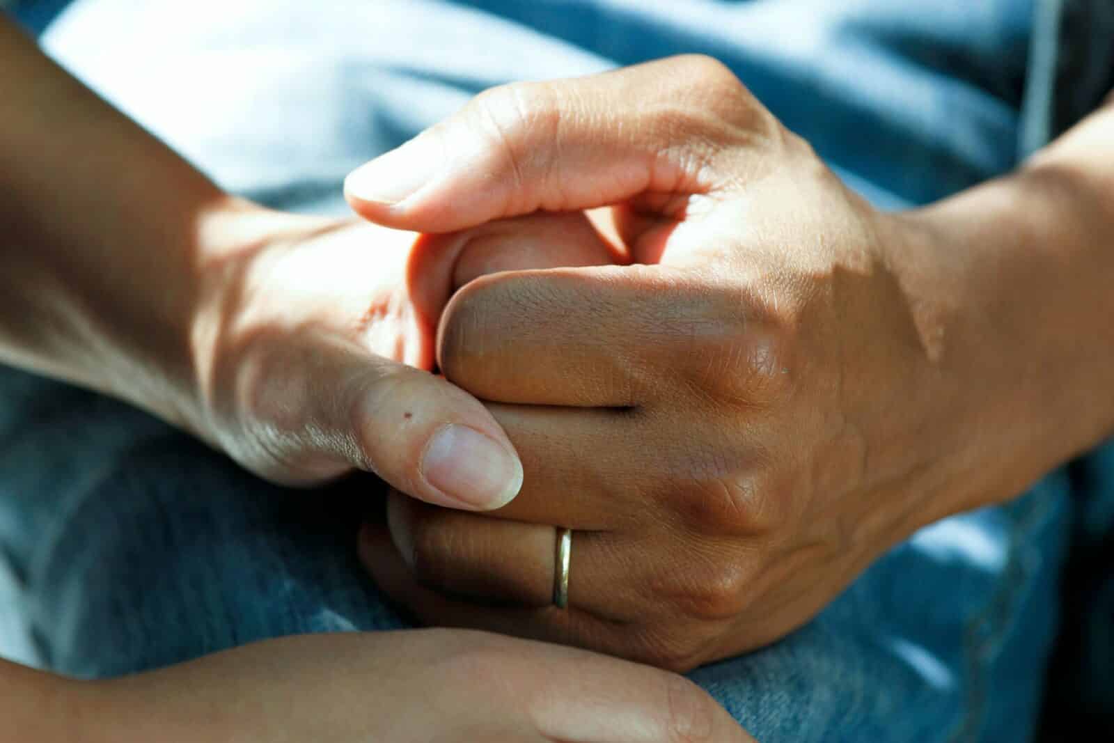 a close up of a hands holding to present a safety net for aging relatives