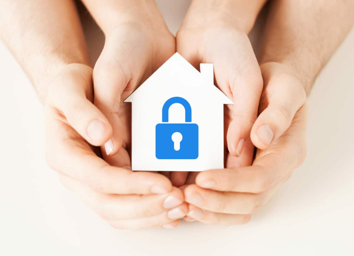 mother and child hands holding a home icon with a blue lock icon in the middle to highlight preventing break-ins