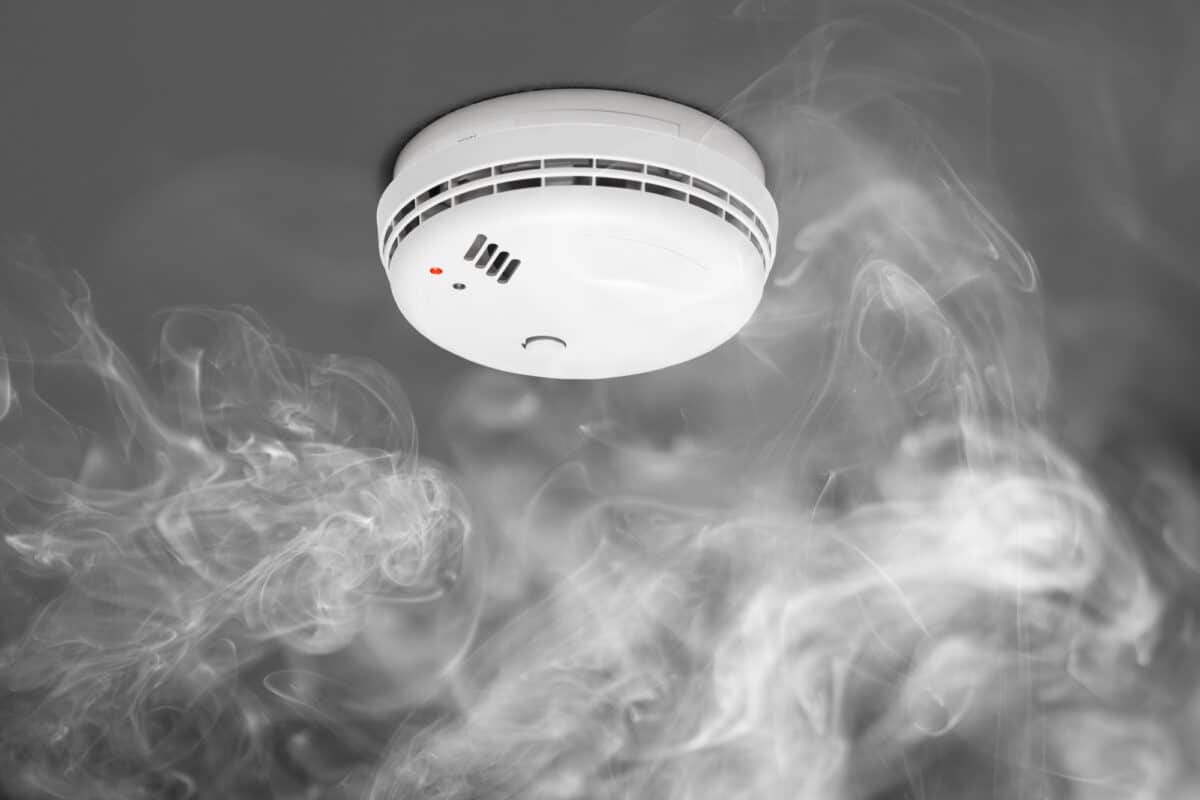 a smoke detector detects smoke rising to the device as an example image of a fire alarm system home automation
